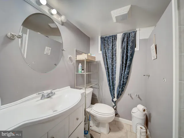 a white toilet sitting next to a bathroom sink