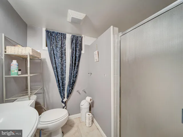 a white toilet sitting next to a small bathroom