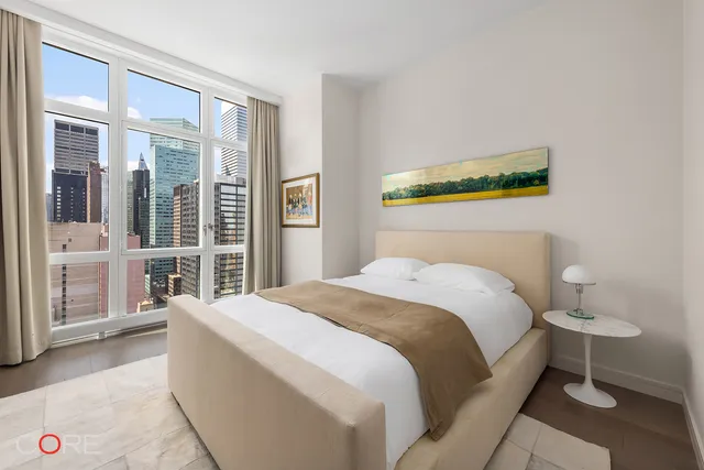 a living room with furniture gym equipment and a large window