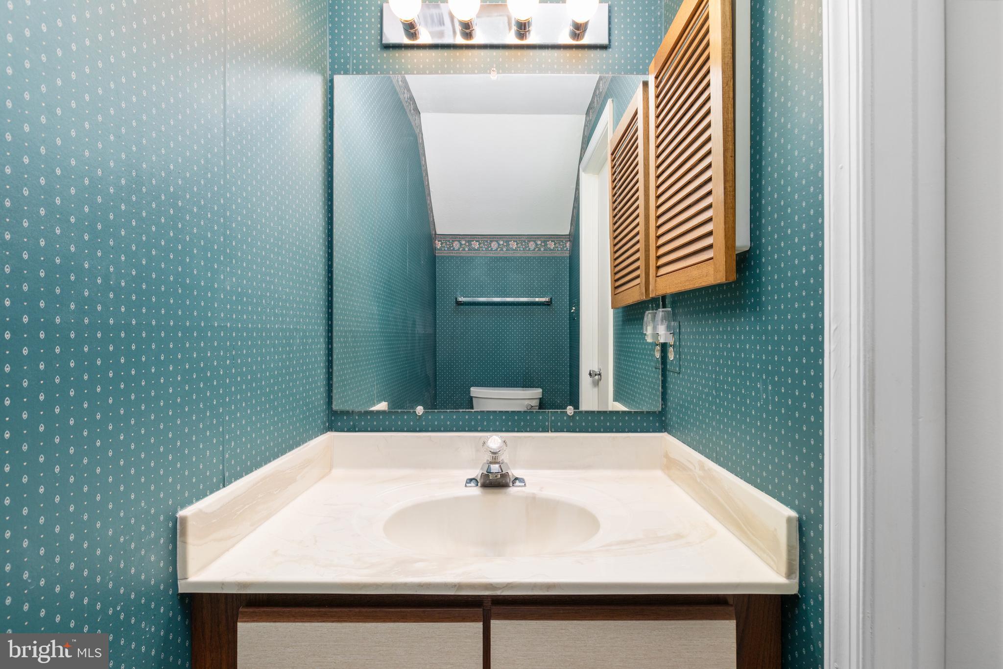 46712 Fielding Terrace Sterling, VA 20164 - Photo 12 of 22 a bathroom with a sink and a mirror