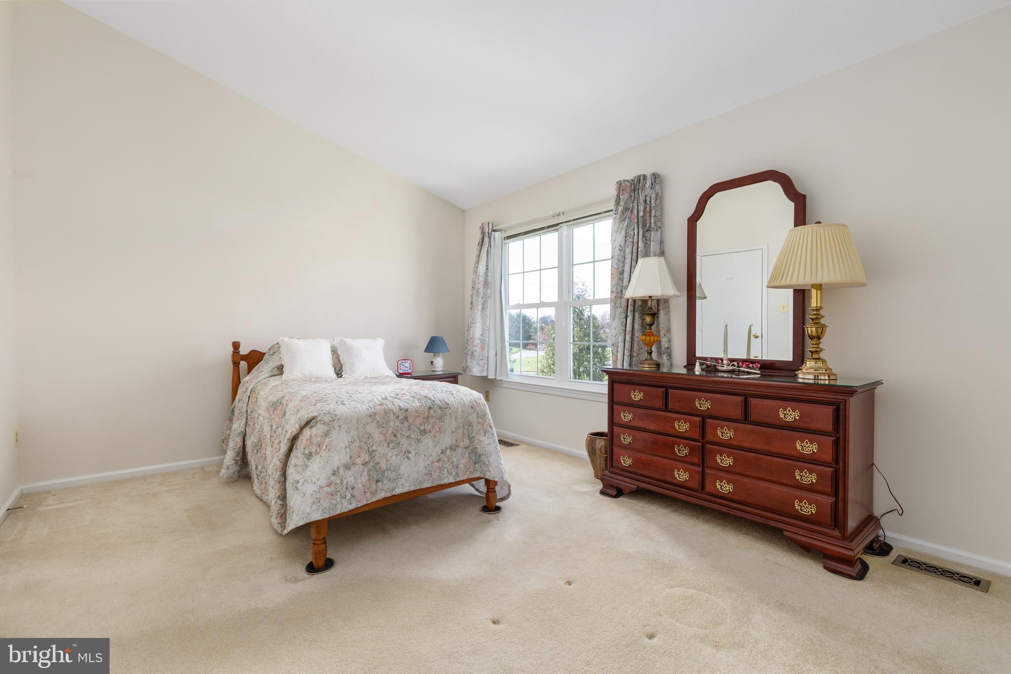 46712 Fielding Terrace Sterling, VA 20164 - Photo 13 of 22 a bedroom with a bed and a dresser