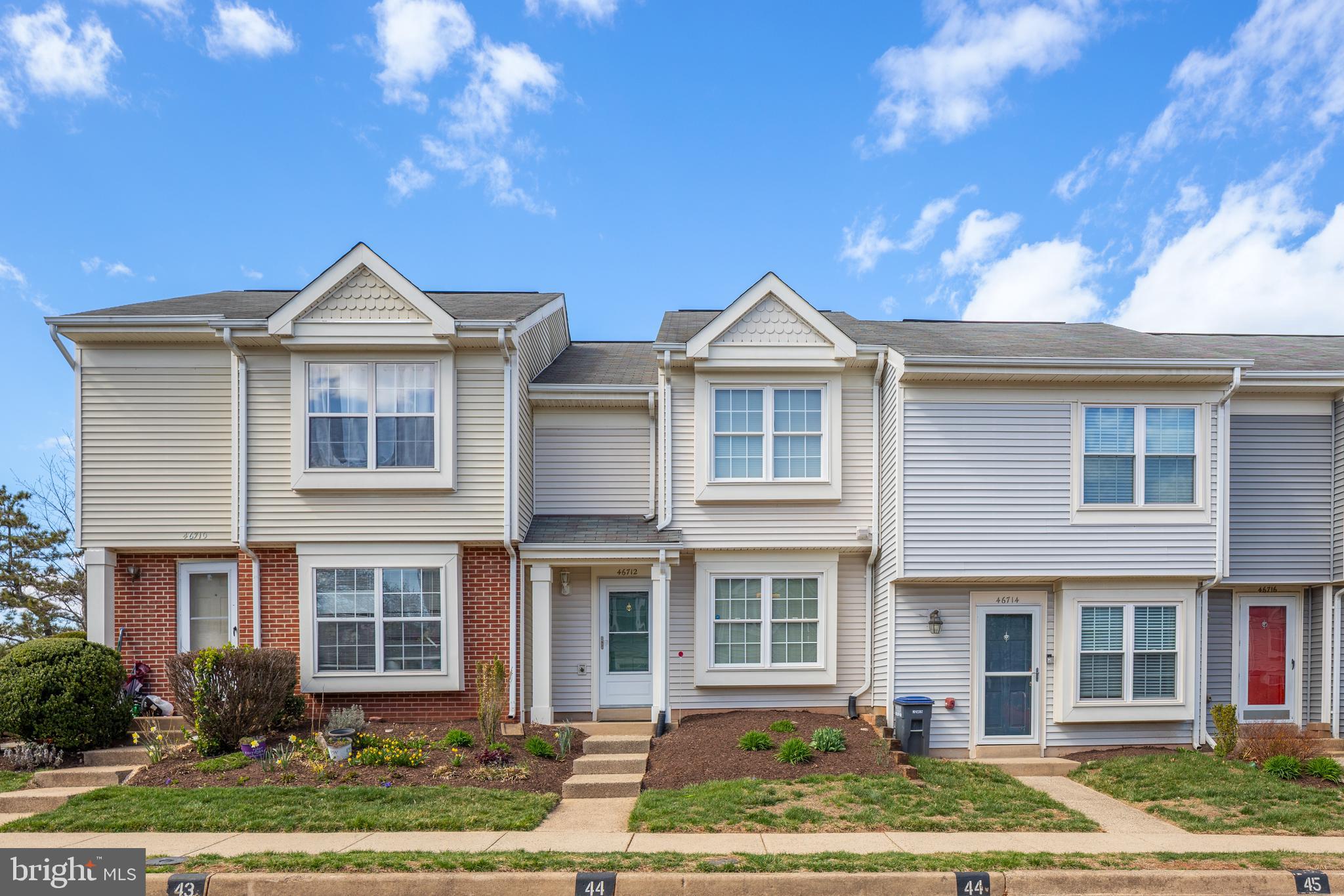46712 Fielding Terrace Sterling, VA 20164 - Photo 2 of 22 a front view of a house with a yard