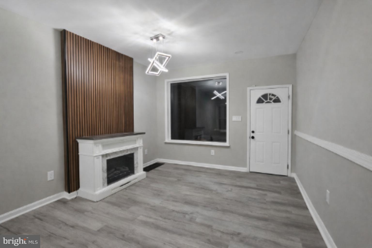 1013 North 10th Street Reading, PA 19604 - Photo 2 of 27 wooden floor fireplace and natural light in room
