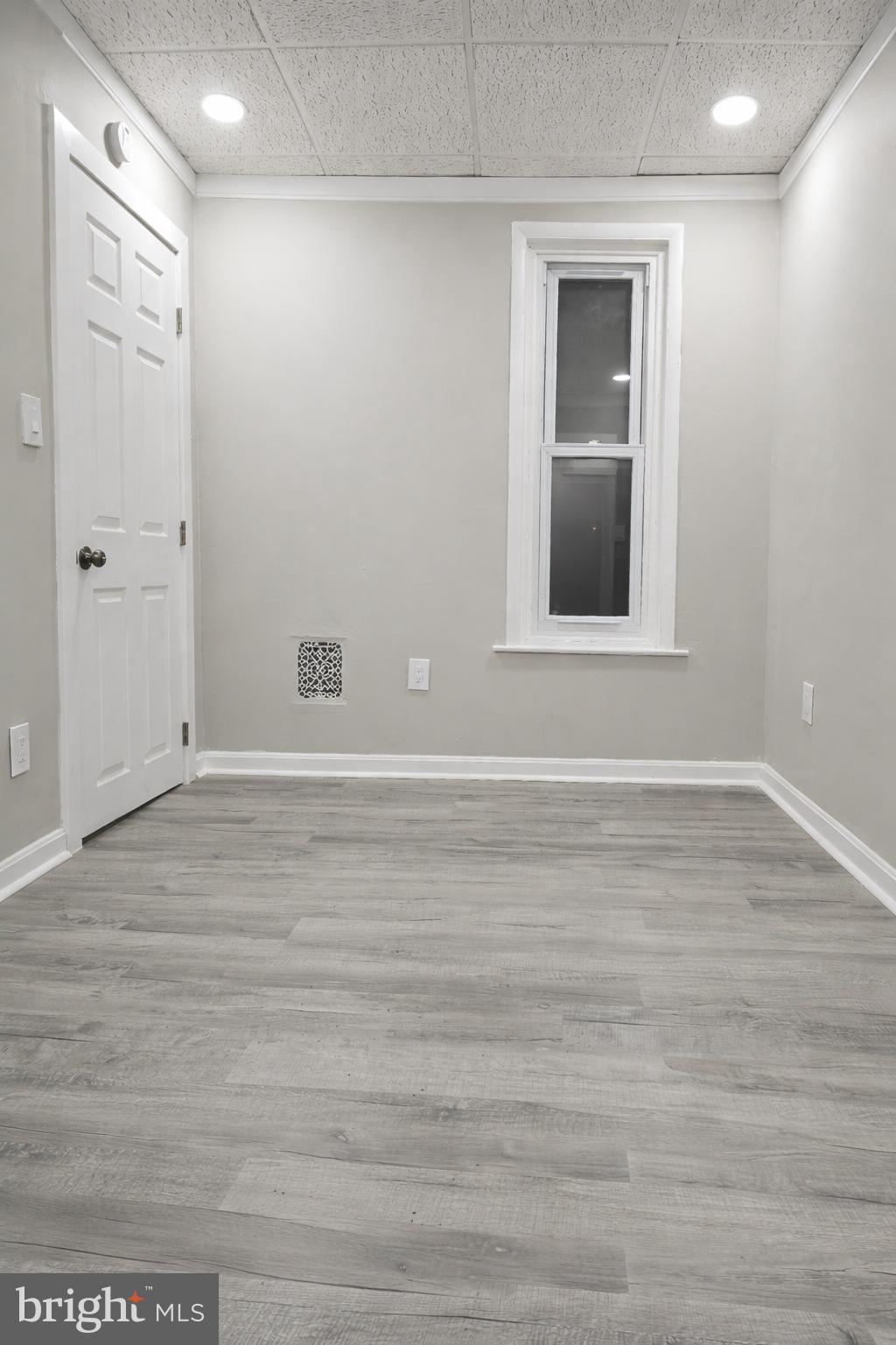 1013 North 10th Street Reading, PA 19604 - Photo 24 of 27 a view of an empty room with wooden floor and a window