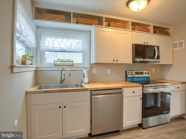 a kitchen with a sink stove and microwave