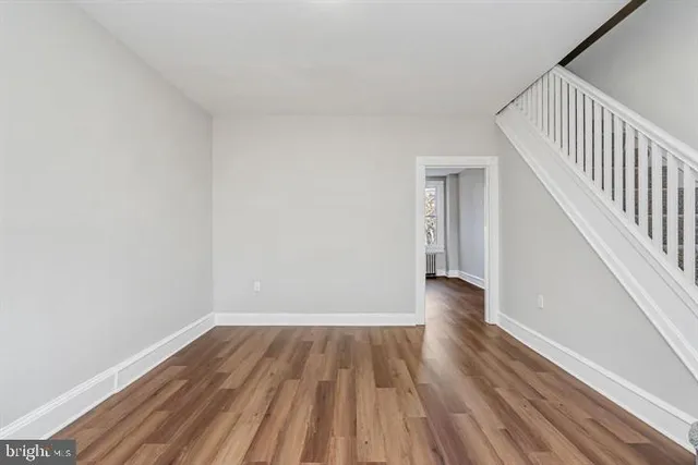 a view of a room with wooden floor and stairs