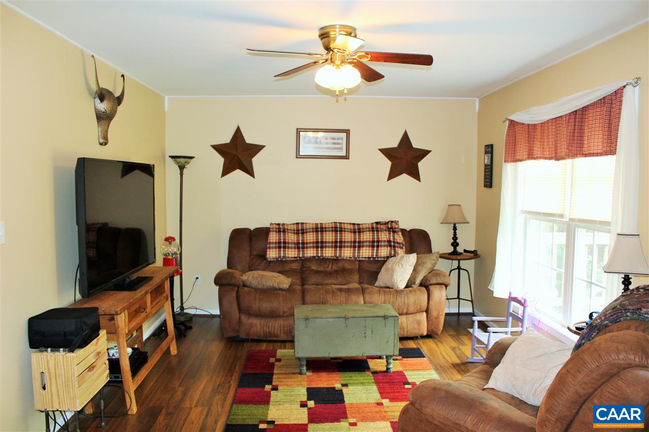 431 Buckner Road Bumpass, VA 23024 - Photo 6 of 34 a living room with furniture and a flat screen tv