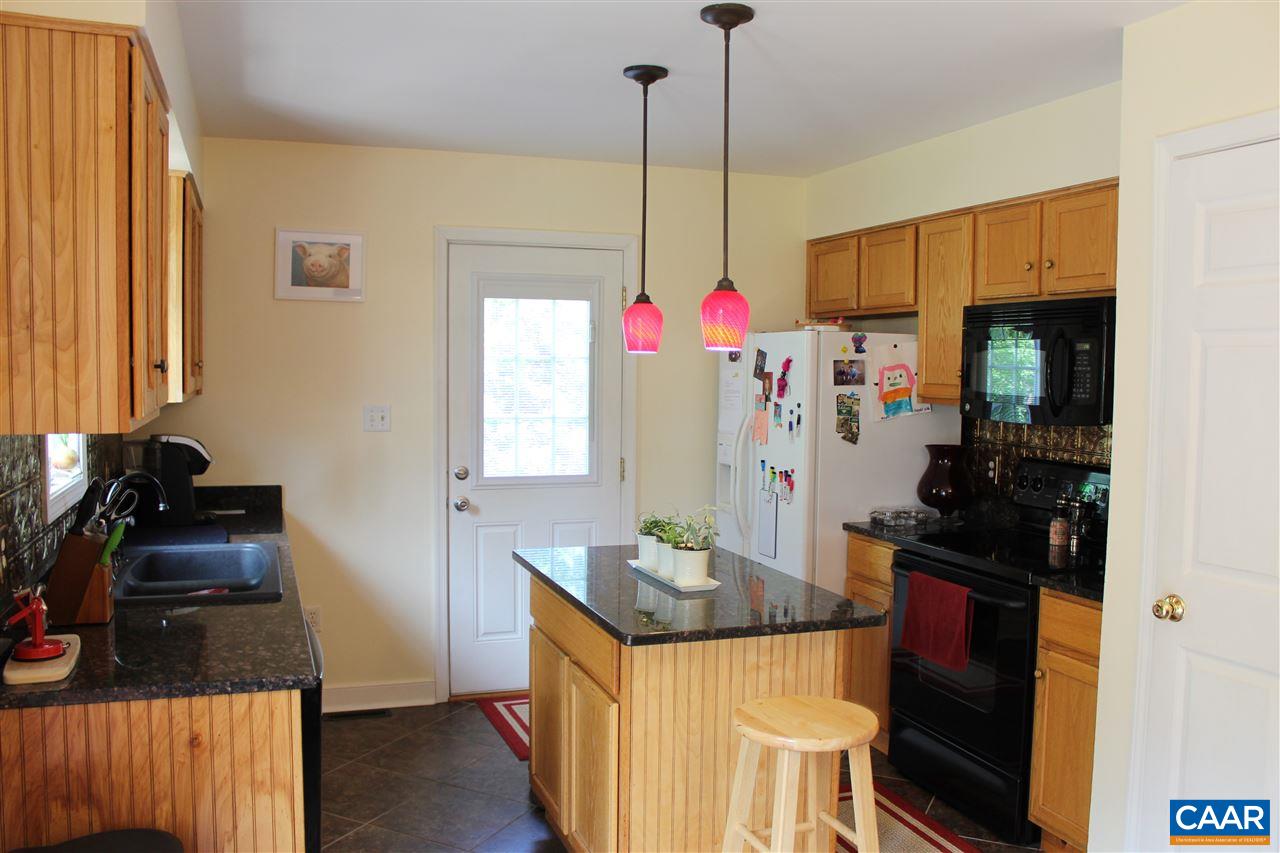 431 Buckner Road Bumpass, VA 23024 - Photo 7 of 34 a kitchen with a refrigerator and a stove