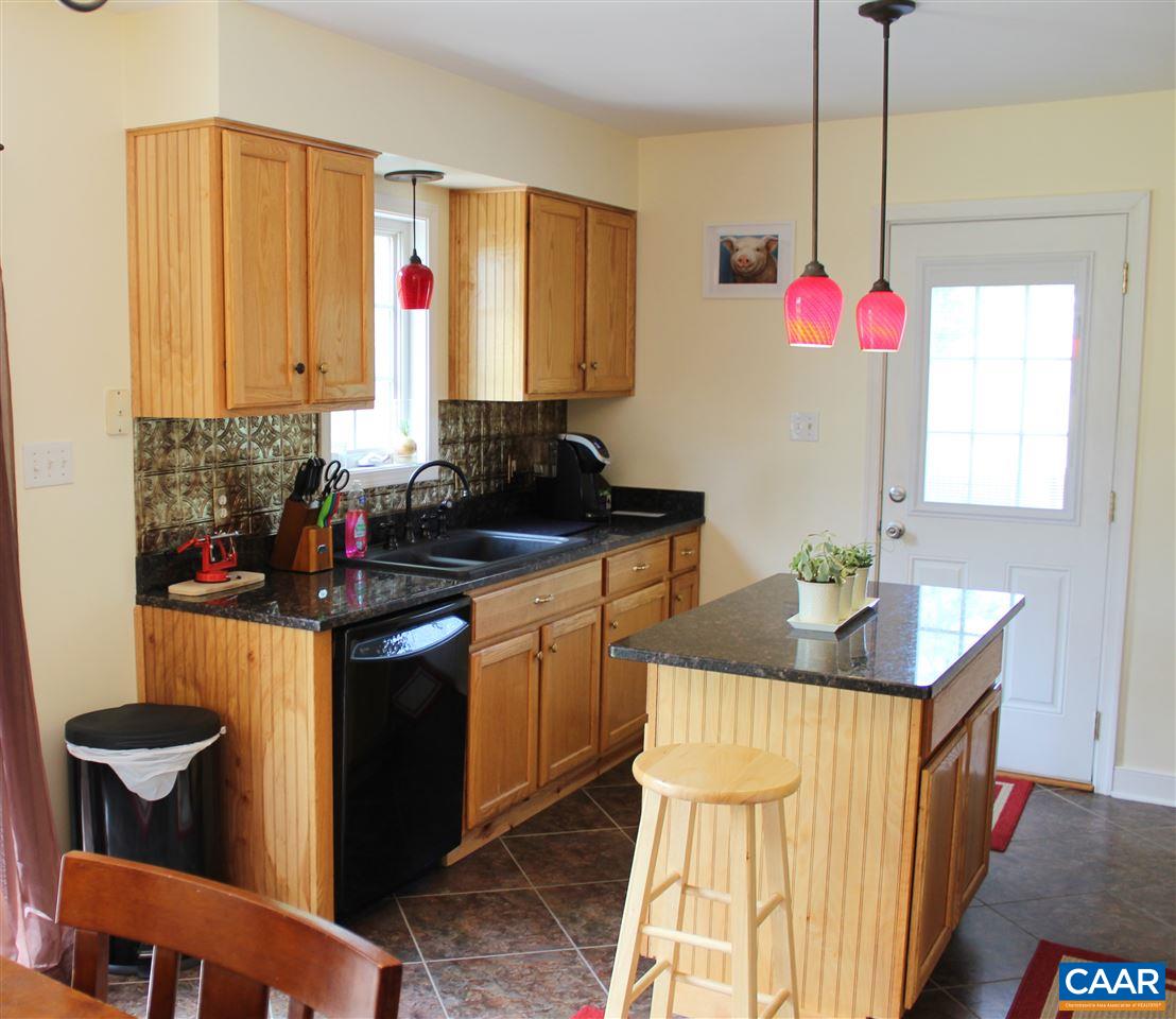 431 Buckner Road Bumpass, VA 23024 - Photo 8 of 34 a kitchen with a sink stove and cabinets