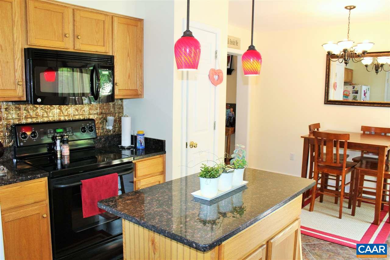 431 Buckner Road Bumpass, VA 23024 - Photo 9 of 34 a kitchen that has a kitchen island stainless steel appliances and a dining table