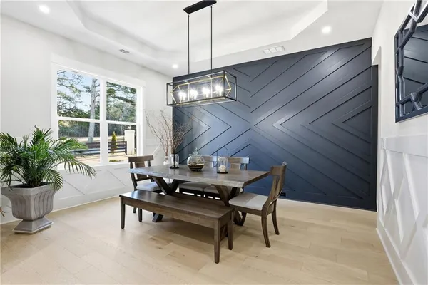 a view of a dining room with furniture window and wooden floor