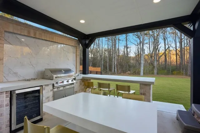 a large white kitchen with a large window