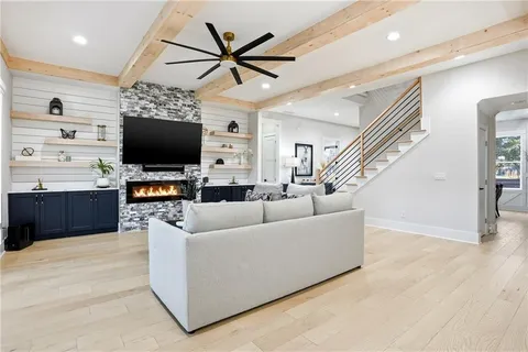 a living room with furniture and a flat screen tv