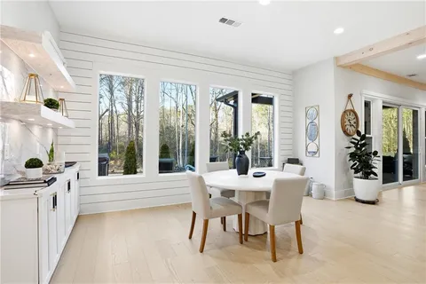 a view of a dining room with furniture window and wooden floor