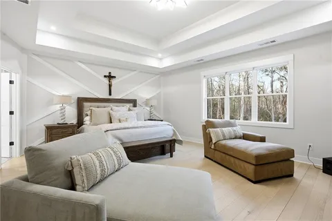 a bedroom with furniture and a large window