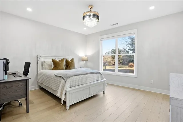 a bedroom with a bed lamp and window