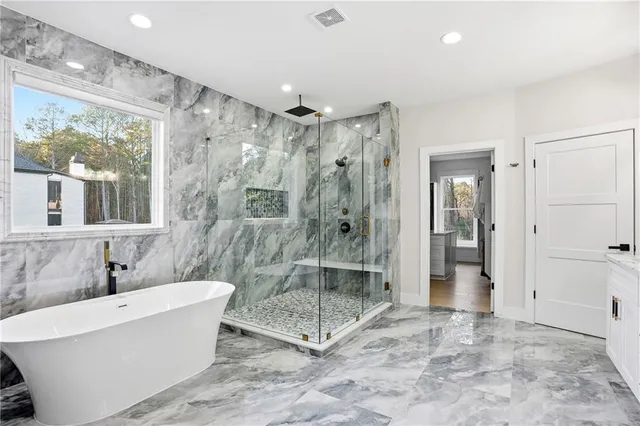 a bathroom with a tub shower and sink
