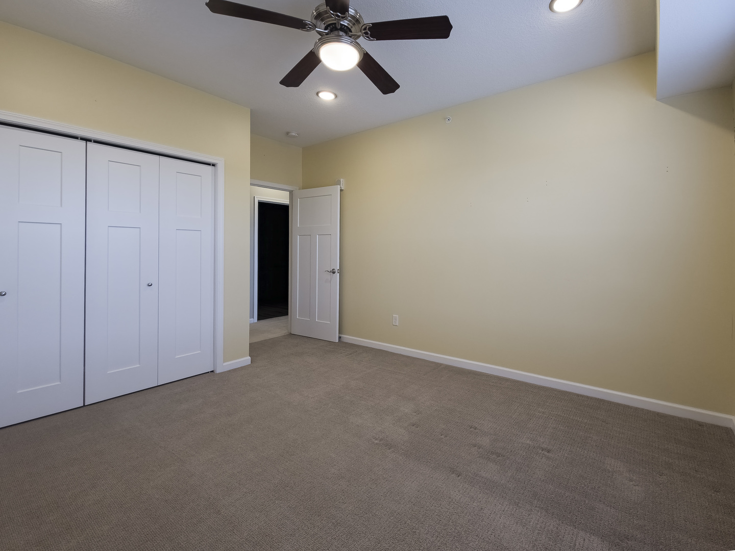2592 Middle Road, Unit 313 Bettendorf, IA 52722 - Photo 30 of 52 an empty room with a ceiling fan and carpet