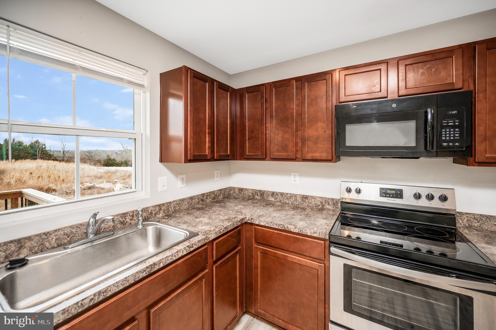 35252 Sara Court Locust Grove, VA 22508 - Photo 7 of 40 a kitchen with granite countertop a stove sink and microwave
