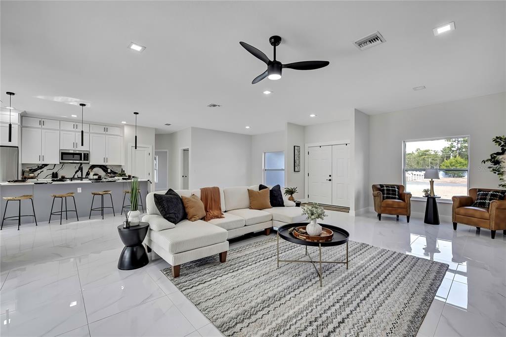 a living room with furniture and a large window