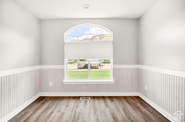 2280 South 450 West Perry, UT 84302 - Photo 20 of 38 Empty room with a wainscoted wall and wood finished floors