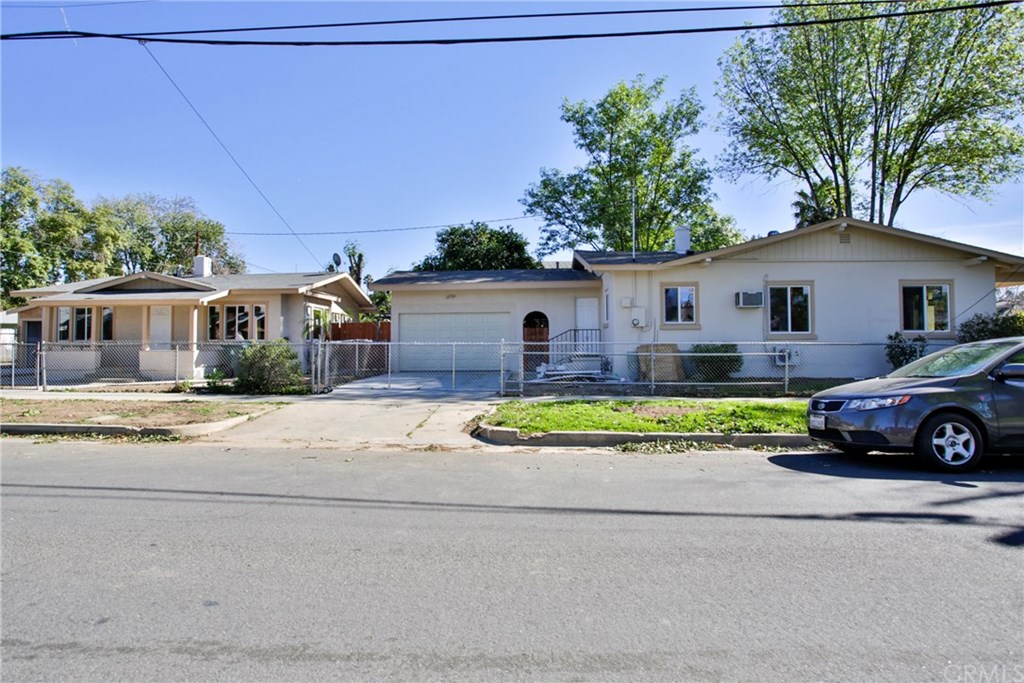 3260 Chestnut Street Riverside, CA 92501 - Photo 1 of 1 a front view of a house with a yard and garage