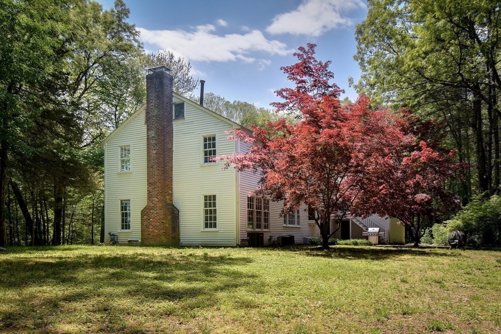 114 Hunters Ridge Road Concord, MA 01742 - Photo 30 of 38 a house with trees in front of it