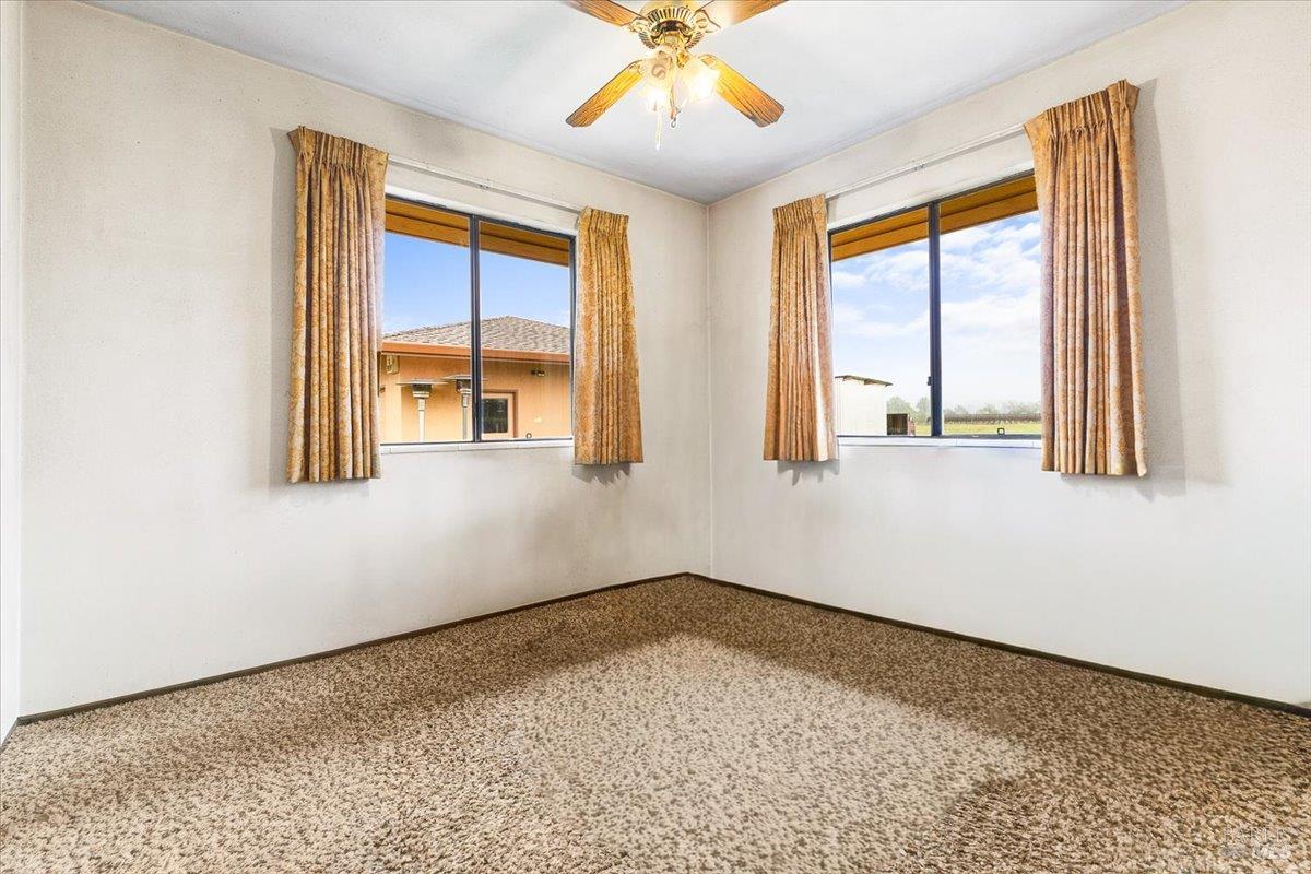 2062 Woolsey Road Fulton, CA 95439 - Photo 28 of 44 an empty room with wooden floor and windows