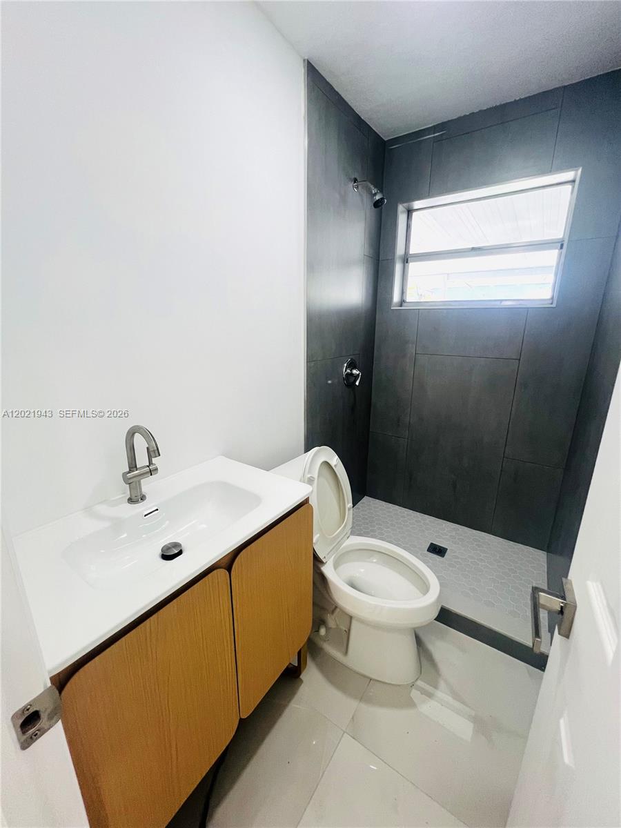 15530 Southwest 295th Terrace Homestead, FL 33033 - Photo 9 of 14 a bathroom with a sink a toilet and shower