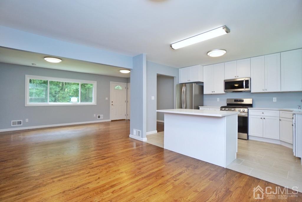 50 Dock Road Matawan, NJ 07747 - Photo 2 of 37 a kitchen with granite countertop a stove a sink and a microwave
