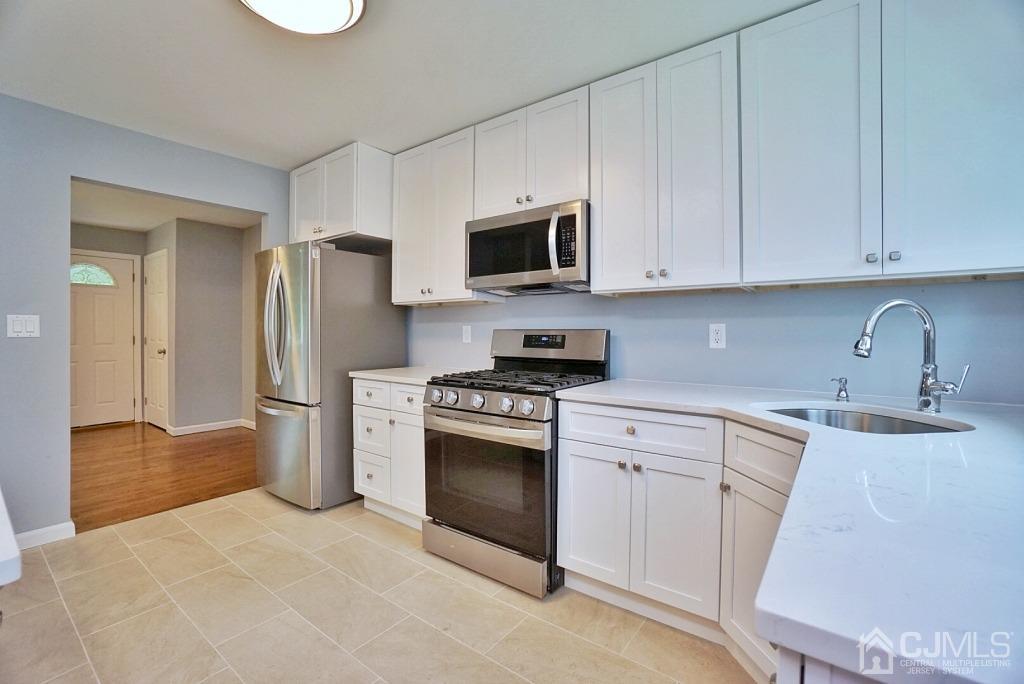 50 Dock Road Matawan, NJ 07747 - Photo 11 of 37 a kitchen with a sink stove and refrigerator