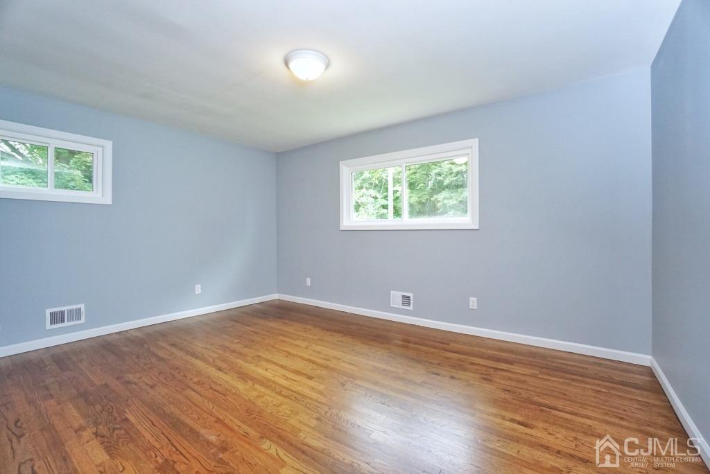 50 Dock Road Matawan, NJ 07747 - Photo 13 of 37 an empty room with wooden floor and windows