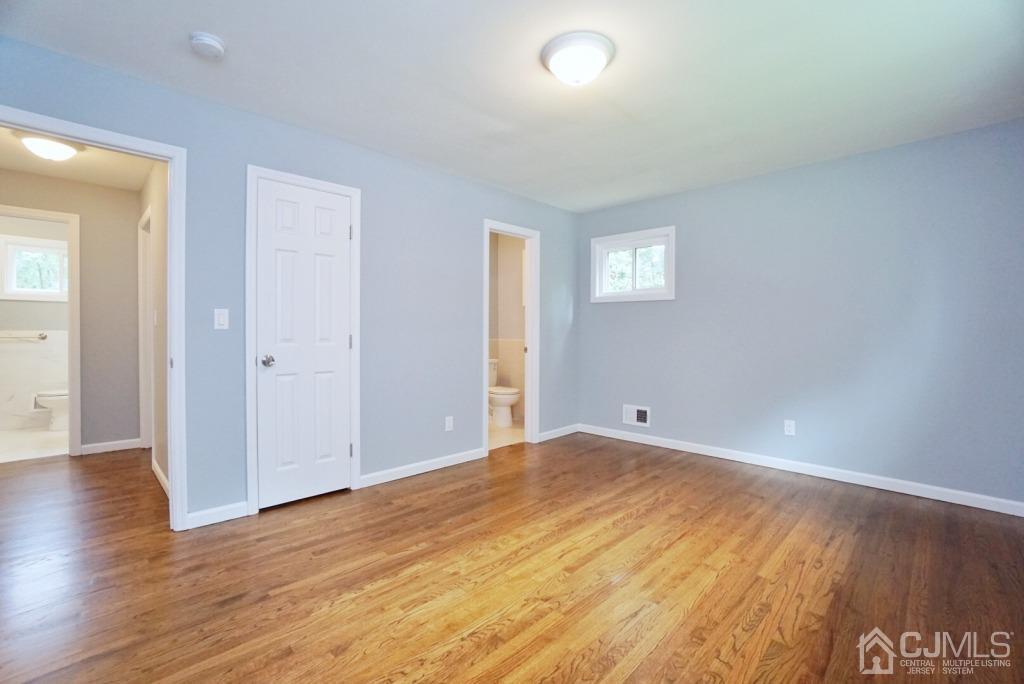 50 Dock Road Matawan, NJ 07747 - Photo 15 of 37 an empty room with wooden floor and windows