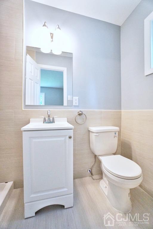 50 Dock Road Matawan, NJ 07747 - Photo 16 of 37 a bathroom with a toilet sink and mirror