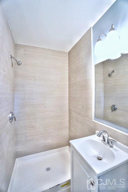 50 Dock Road Matawan, NJ 07747 - Photo 18 of 37 a bathroom with a sink mirror and shower