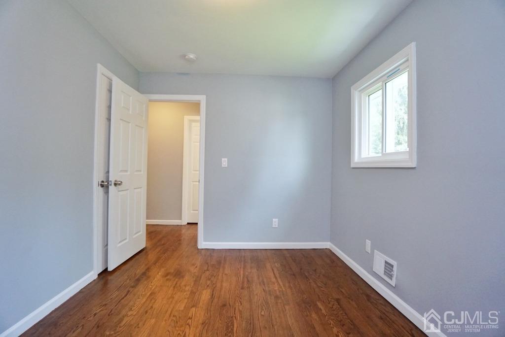 50 Dock Road Matawan, NJ 07747 - Photo 20 of 37 an empty room with wooden floor and windows