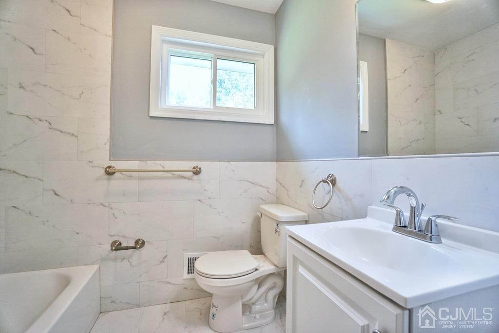 50 Dock Road Matawan, NJ 07747 - Photo 21 of 37 a bathroom with a toilet sink and mirror