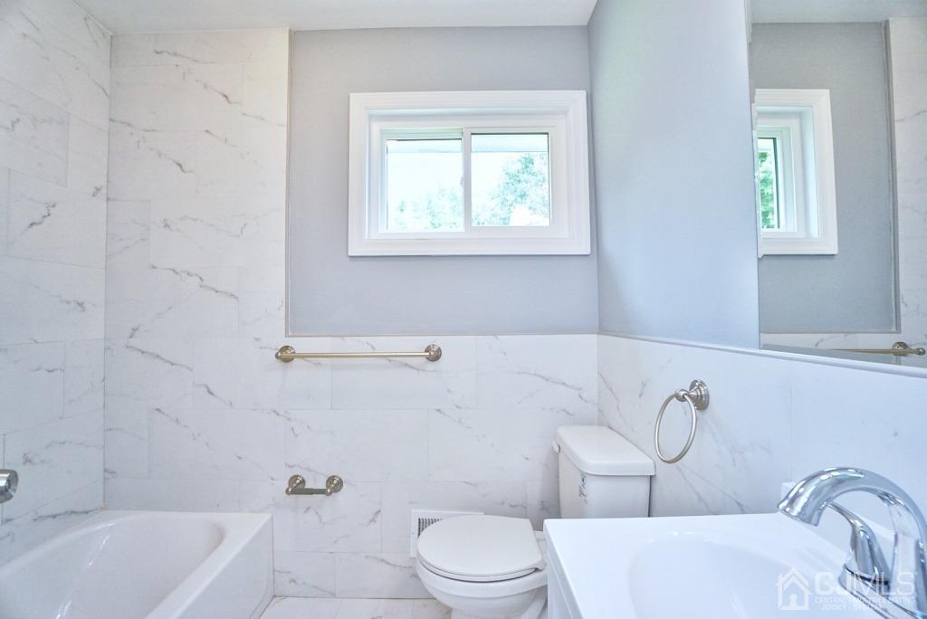 50 Dock Road Matawan, NJ 07747 - Photo 22 of 37 a bathroom with a sink a toilet and a bathtub