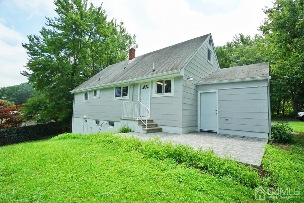 50 Dock Road Matawan, NJ 07747 - Photo 34 of 37 a backyard of a house with table and chairs and large tree