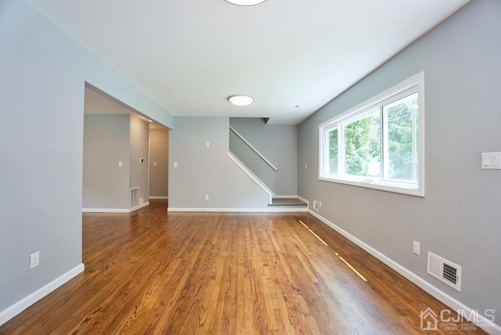 50 Dock Road Matawan, NJ 07747 - Photo 5 of 37 a view of an empty room with wooden floor and a window