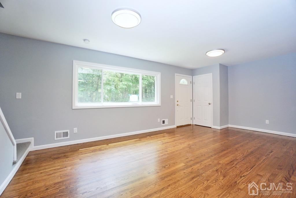 50 Dock Road Matawan, NJ 07747 - Photo 6 of 37 an empty room with wooden floor and windows