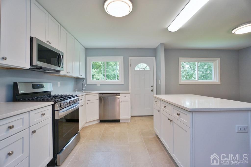 50 Dock Road Matawan, NJ 07747 - Photo 10 of 37 a kitchen with stainless steel appliances granite countertop a stove a sink and a microwave