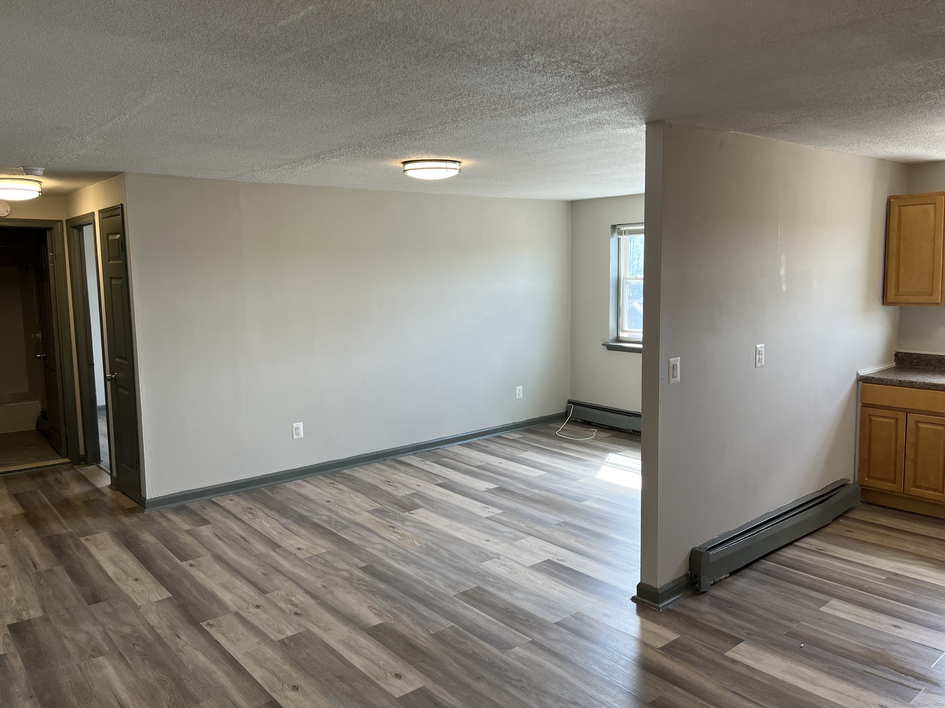 32 Cook Avenue, Unit D23 Meriden, CT 06451 - Photo 4 of 12 a view of empty room with wooden floor