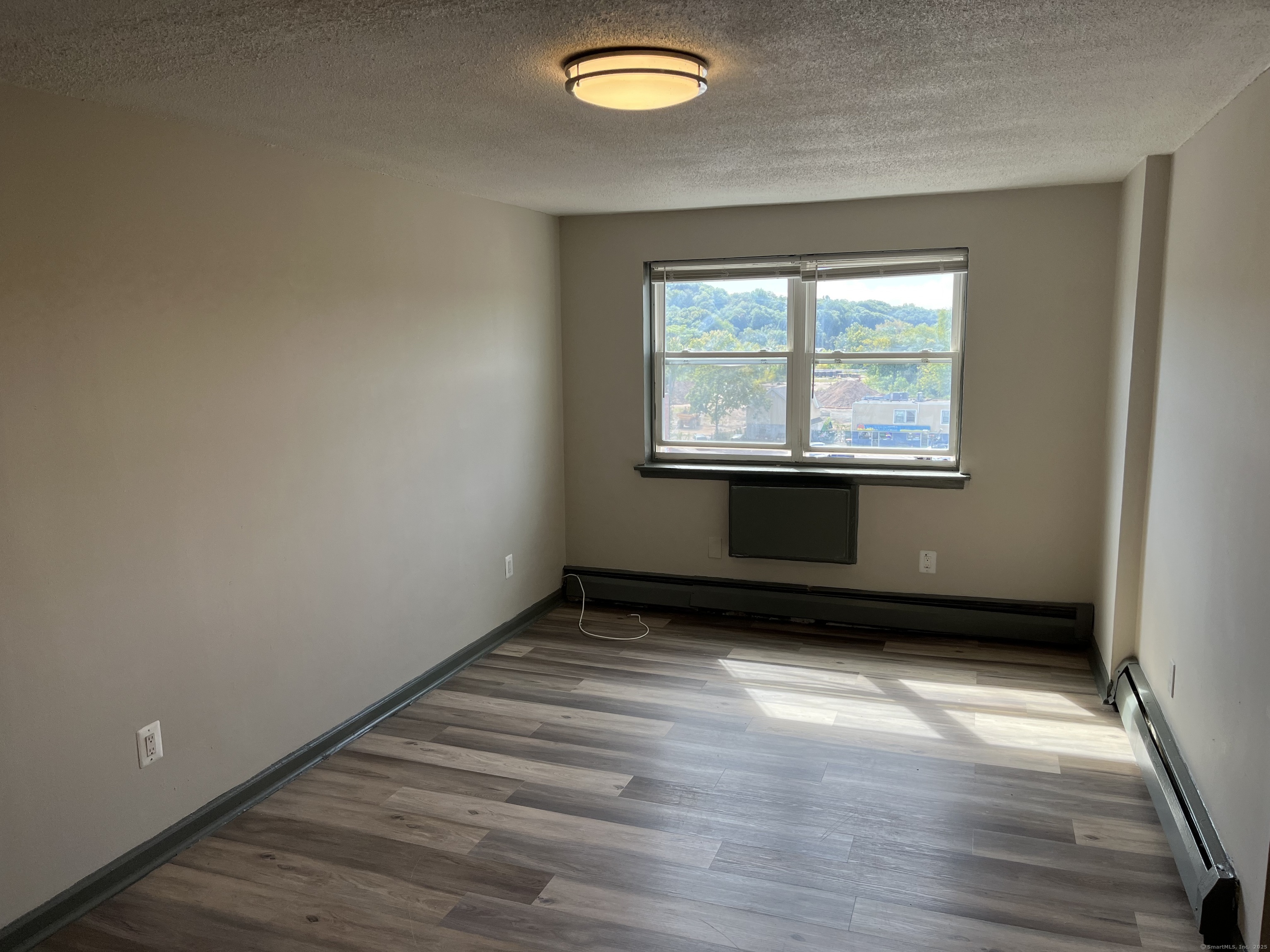 32 Cook Avenue, Unit D23 Meriden, CT 06451 - Photo 5 of 12 an empty room with wooden floor and windows