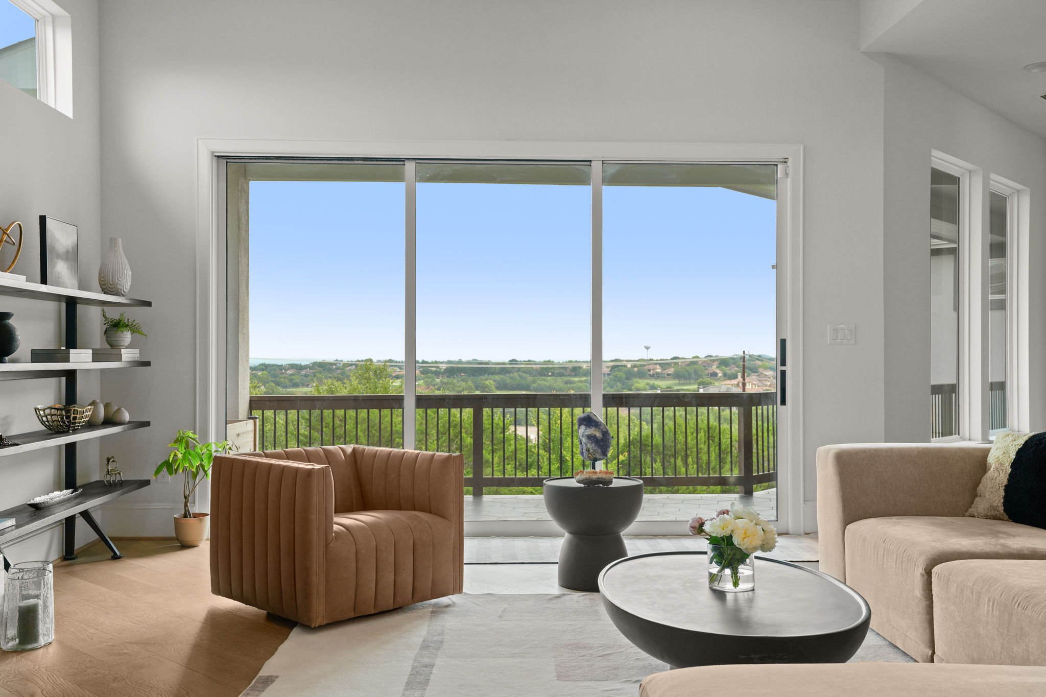 104 Lodestone Cove Austin, TX 78738 - Photo 3 of 40 Floor-to-ceiling glass doors reveal an inspiring green landscape with distant hills.