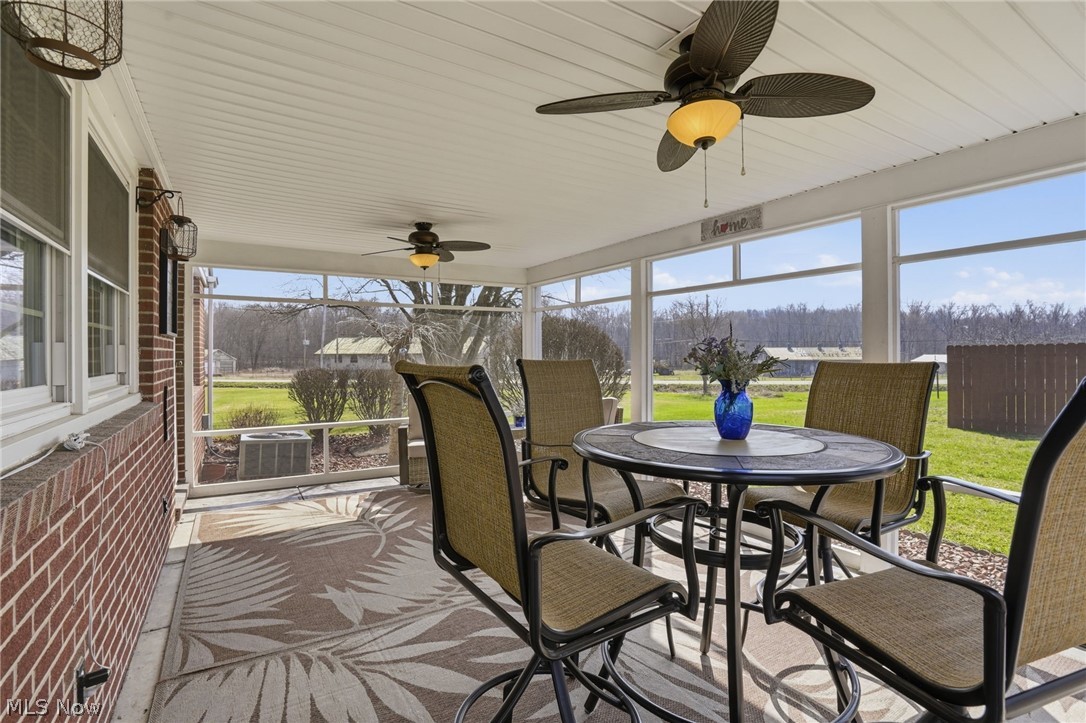 6655 Ceramic Road Crooksville, OH 43731 - Photo 30 of 34 Sunroom with ceiling fan and outdoor dining space