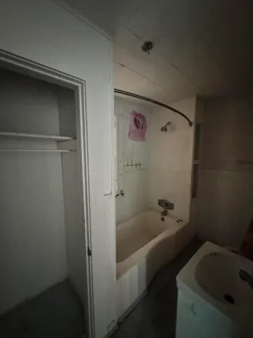 a bathroom with a sink a mirror and shower