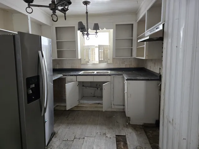 a kitchen with a refrigerator and a sink