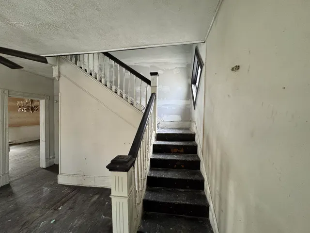 an empty room with closet and windows