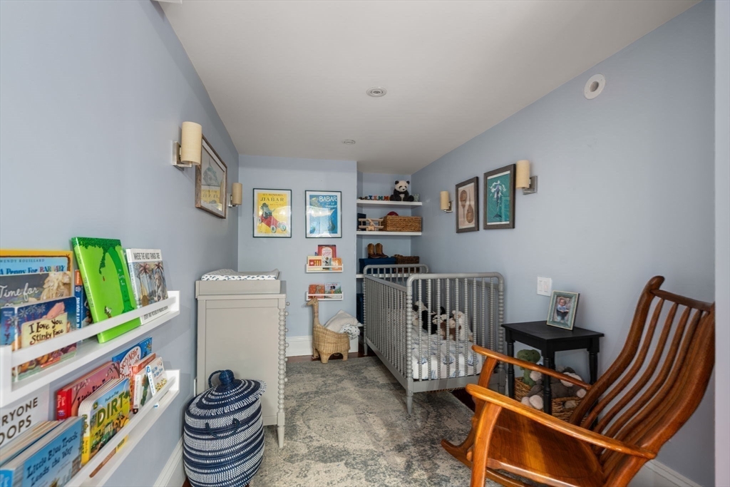 32 Rutland Square, Unit 1 Boston, MA 02118 - Photo 16 of 24 a living room with furniture and a baby crib